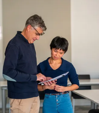 Executive MBA vs MBA Un enseignant en train de consulter les notes d’une étudiante.